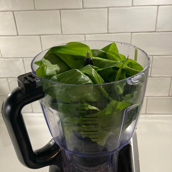 Food processor with wild garlic ready to be blasted