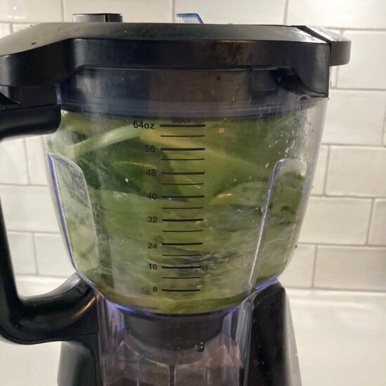 wild garlic leaves being blended in a food processor